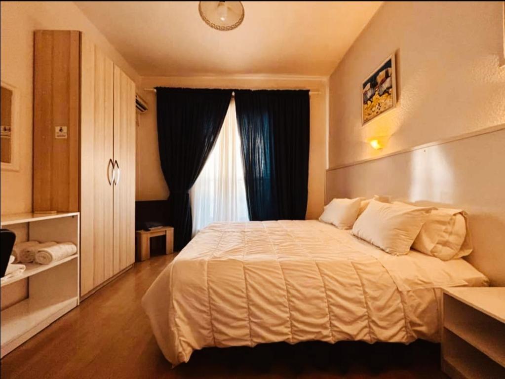 a bedroom with a large bed and a window at Tirana Central GuestHouse in Tirana