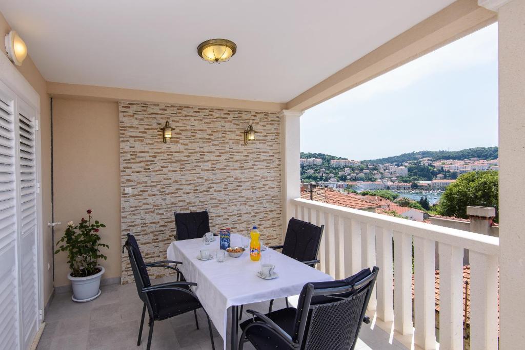 a white table and chairs on a balcony at Apartment Violeta 1 with private terrace in Dubrovnik