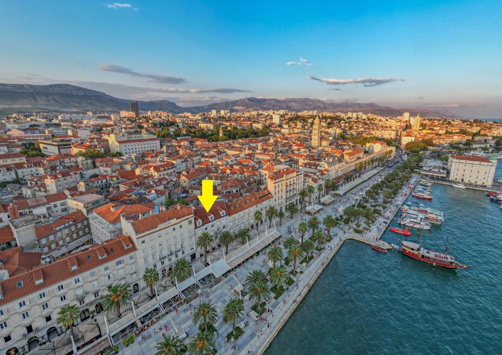 an aerial view of a city with a yellow arrow at Trecento Boutique Rooms in Split