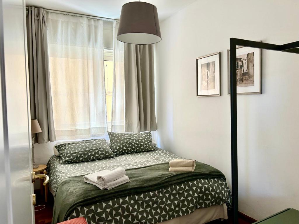 a small bedroom with a bed and a window at Taormina Casa Liliana in Taormina