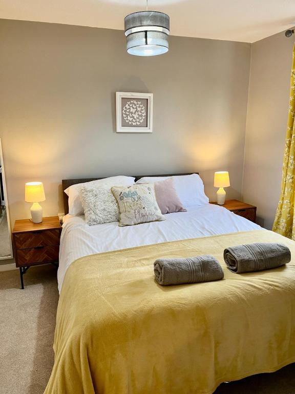 a bedroom with a bed with two pillows on it at Canada House - Sleeps 6 -3 King or 6 Single Ideal for contractors in Warrington