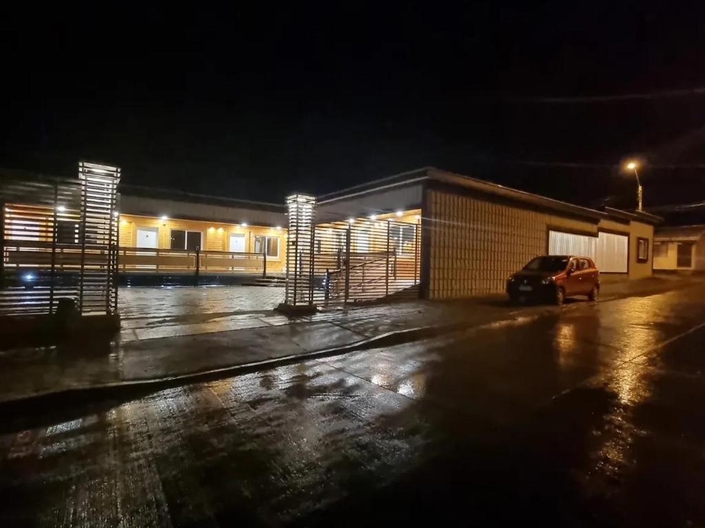 a car parked in front of a building at night at Loft Altos Suite in Puerto Natales