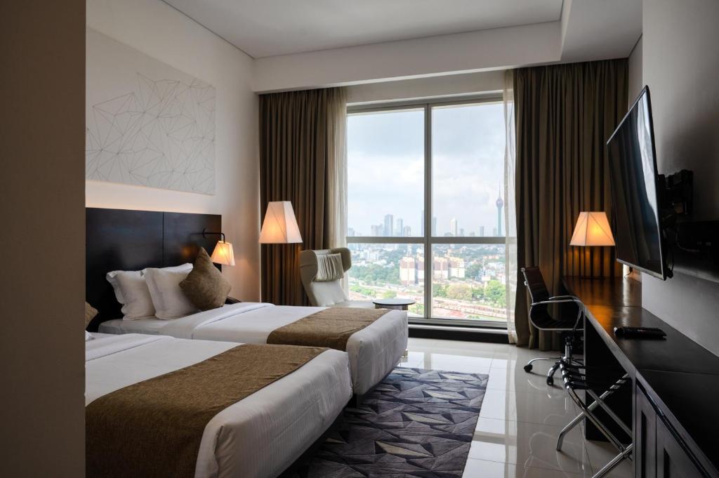 Postel nebo postele na pokoji v ubytování Orion City Hotel