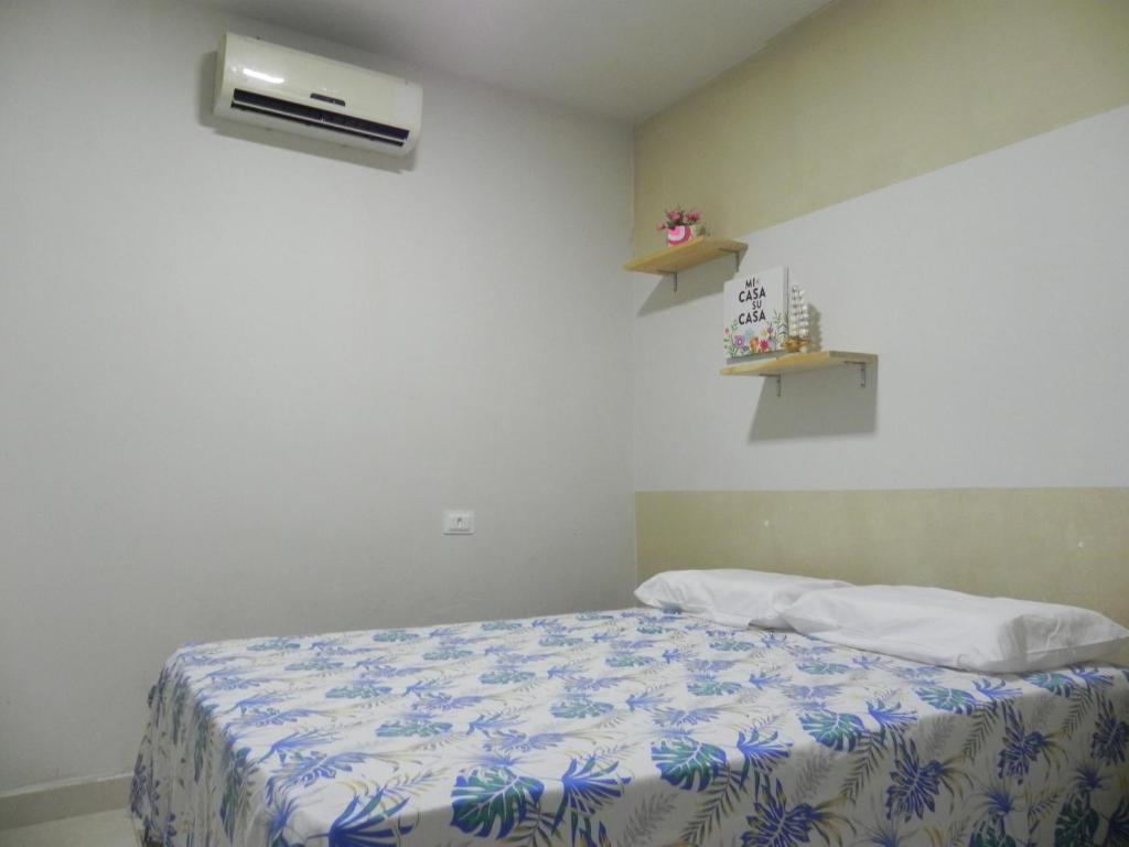 a bedroom with a bed and a air conditioner at Casa Paraiso Maragogi in Maragogi