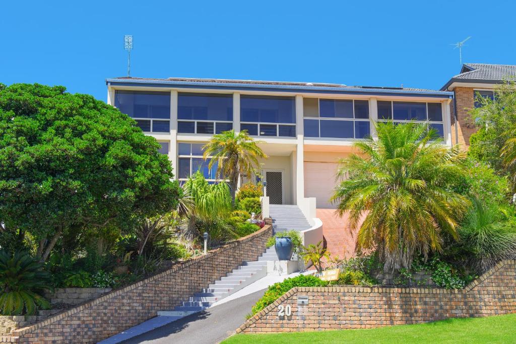 un grand bâtiment avec des palmiers devant lui dans l'établissement Ocean View, à Port Macquarie