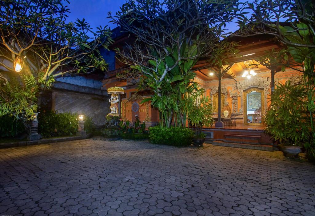 a house with a courtyard with trees and plants at KUDESA Homestay by Pramana Villas in Ubud