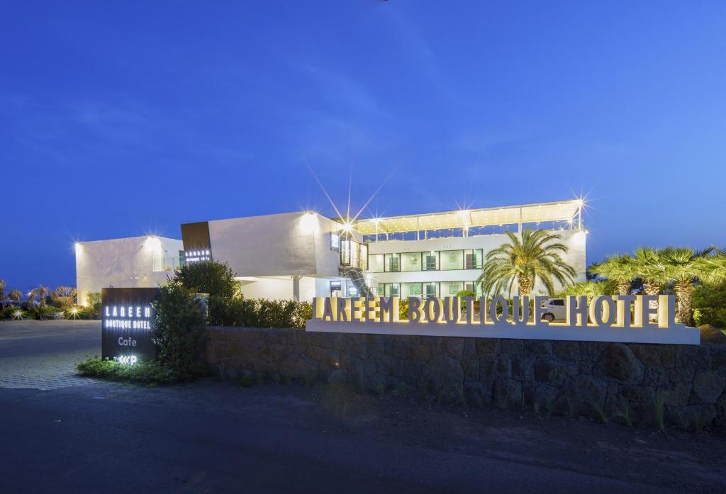 a building with a sign in front of it at Lareem Boutique Hotel in Seogwipo