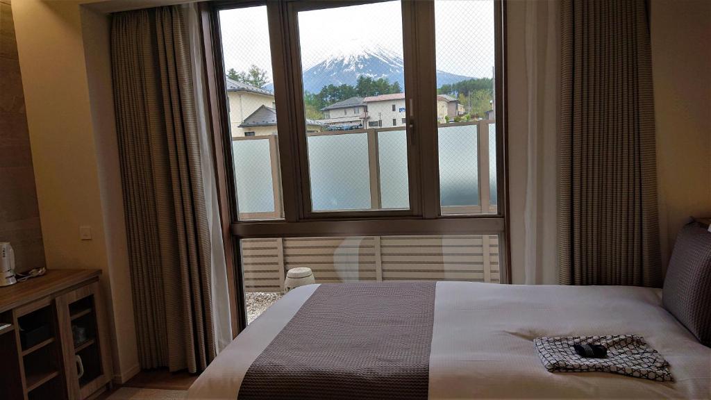 Postel nebo postele na pokoji v ubytování West Inn Fuji-Yoshida