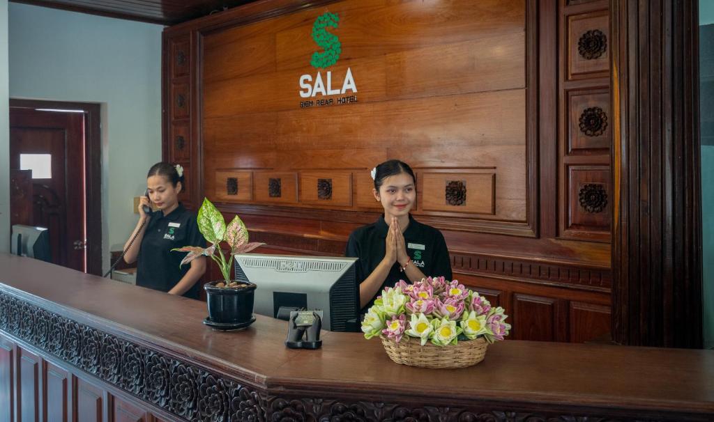 a woman standing in front of a mirror at Sala Siem Reap Hotel in Siem Reap