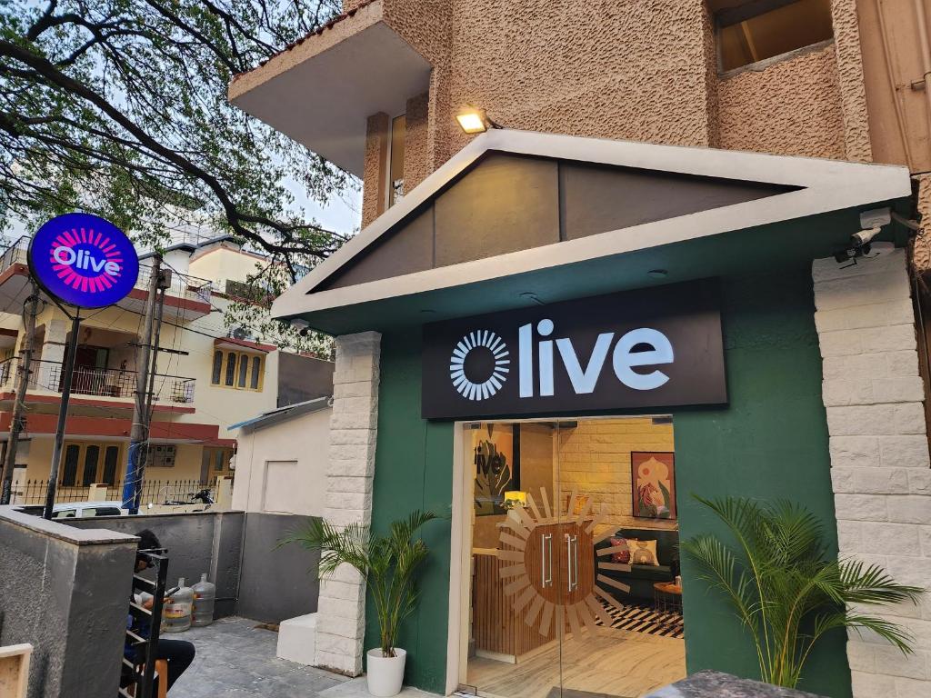 a store with a live sign on the front of it at Olive Indiranagar Metro - by Embassy Group in Bangalore