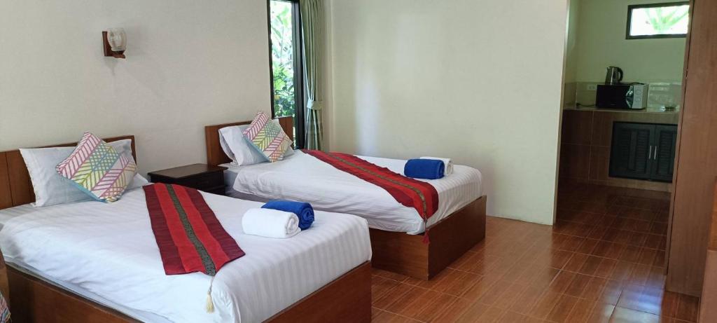 Postel nebo postele na pokoji v ubytování Baan Suan Villas Resort