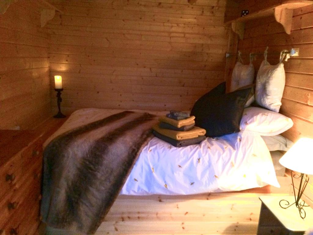 a bedroom with a bed with books on it at Woodman's Rest in Kirdford