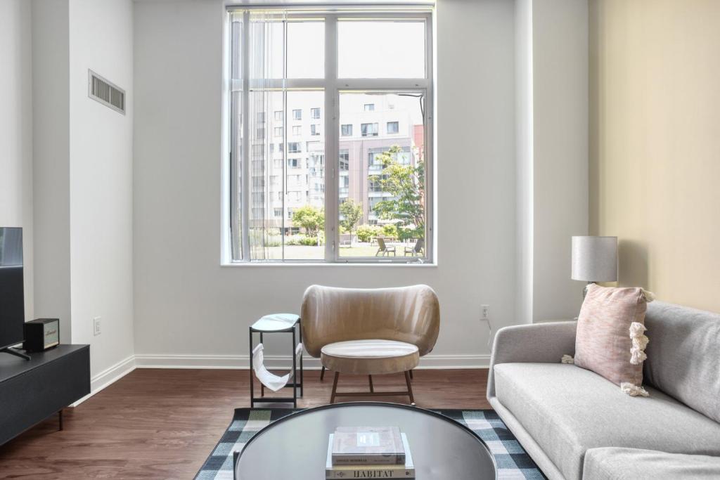 a living room with a couch and a table at Kendall Square 1BR w Concierge Gym nr MIT BOS-716 in Boston