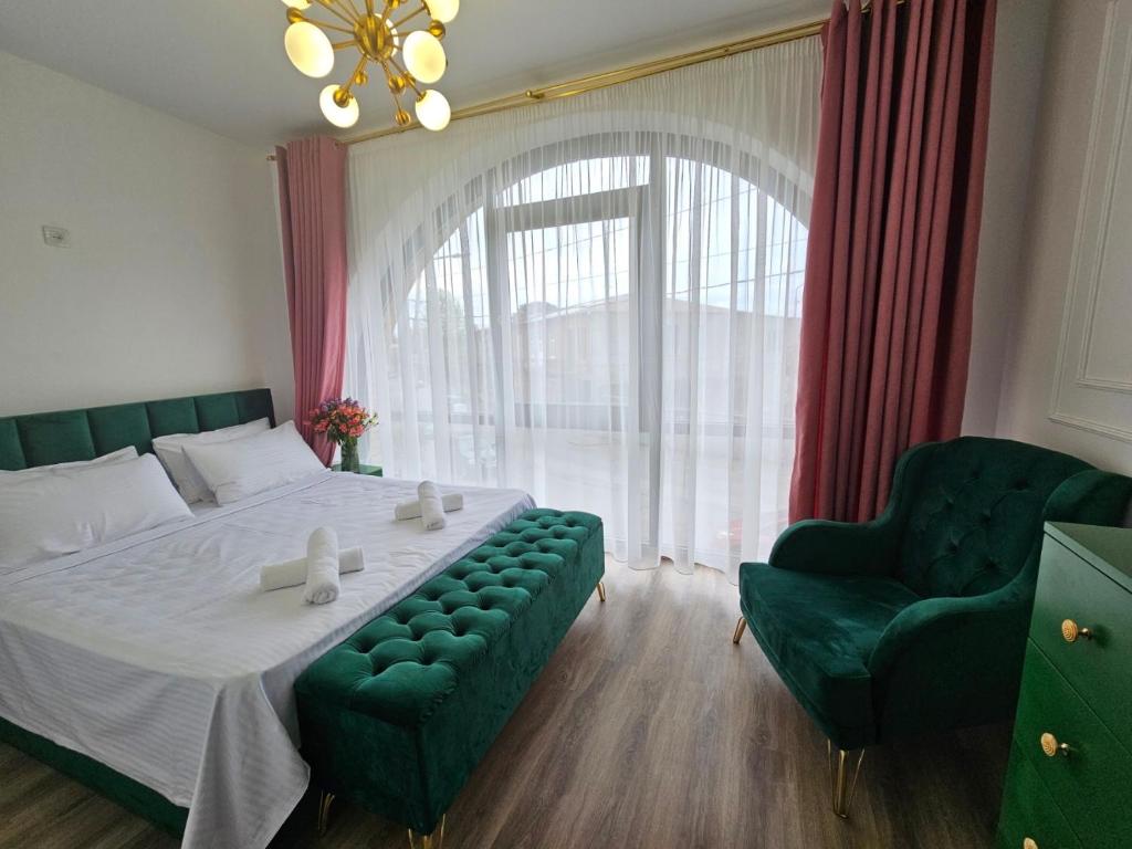 a bedroom with a large bed and a green couch at Boutique Hotel Honey in Kutaisi