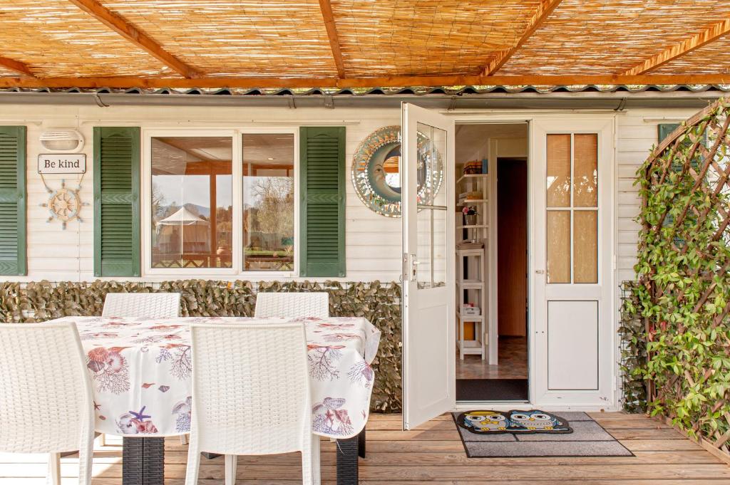 a patio with a table and chairs on a porch at Oasis on the river 2 in Marina di Pisa