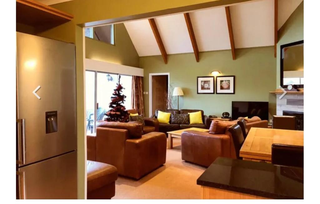 a living room with couches and a christmas tree at Kilconquhar castle estate villa 6, 4 bed sleeps 10 in Fife
