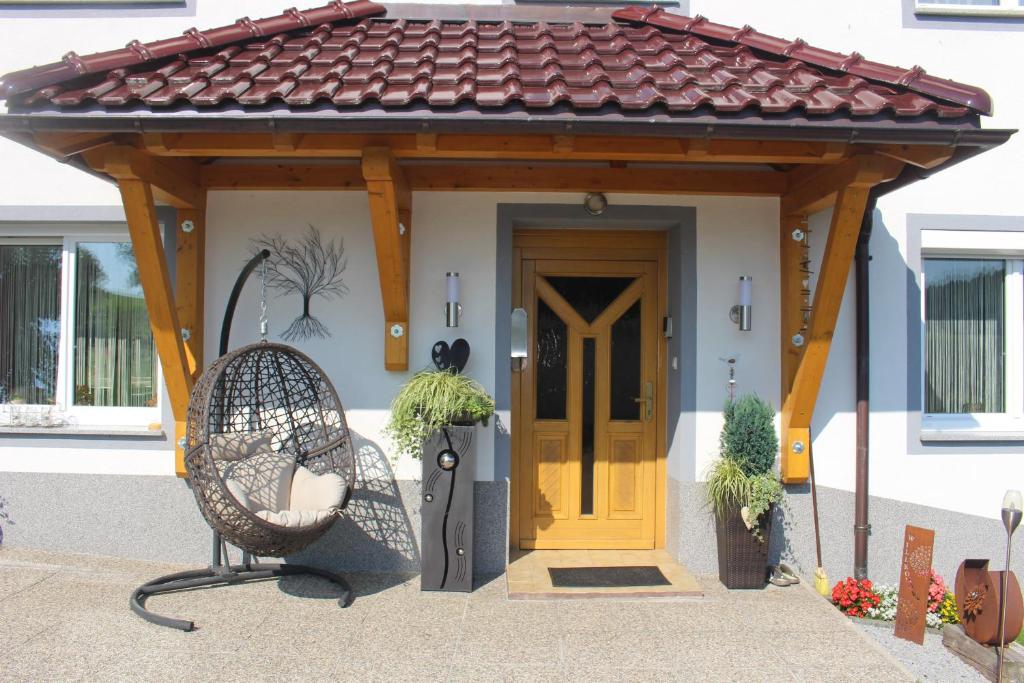 a gazebo with a yellow door on a house at Ferienhof Schaubmeier in Klaffer am Hochficht