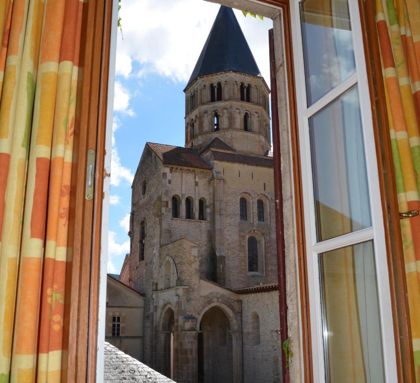 a view of a church through a window at Hotel de Bourgogne in Cluny