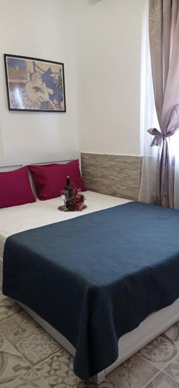 a bedroom with a large bed with a blue blanket at Angel Room 2 in Nea Plagia
