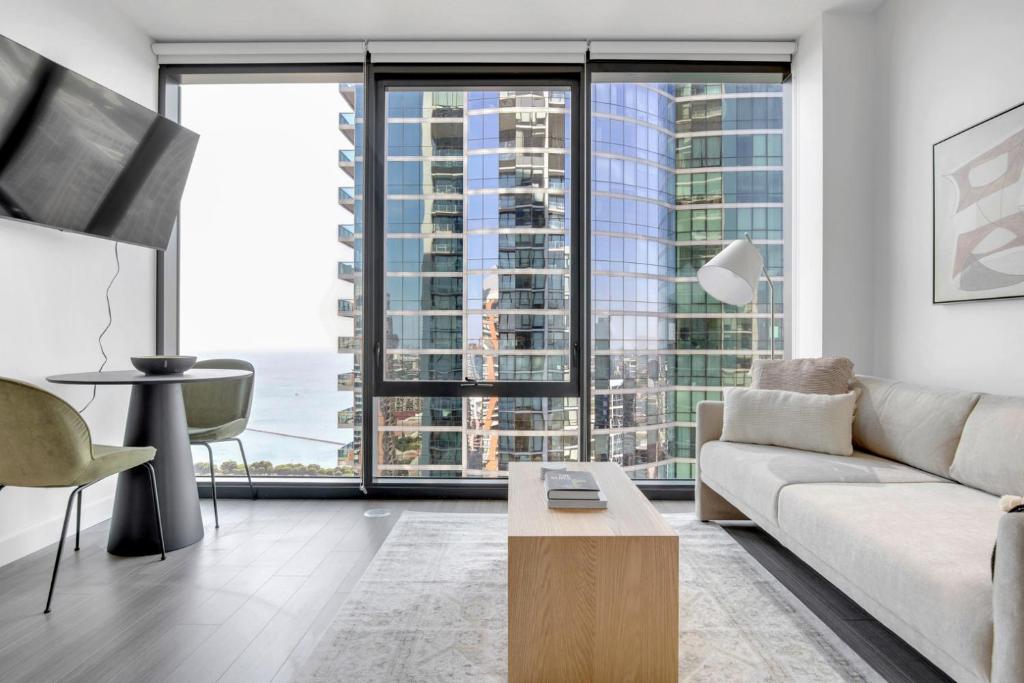 a living room with a couch and a large window at S Loop Studio w Pool Gym Spa nr Grant Park CHI-739 in Chicago