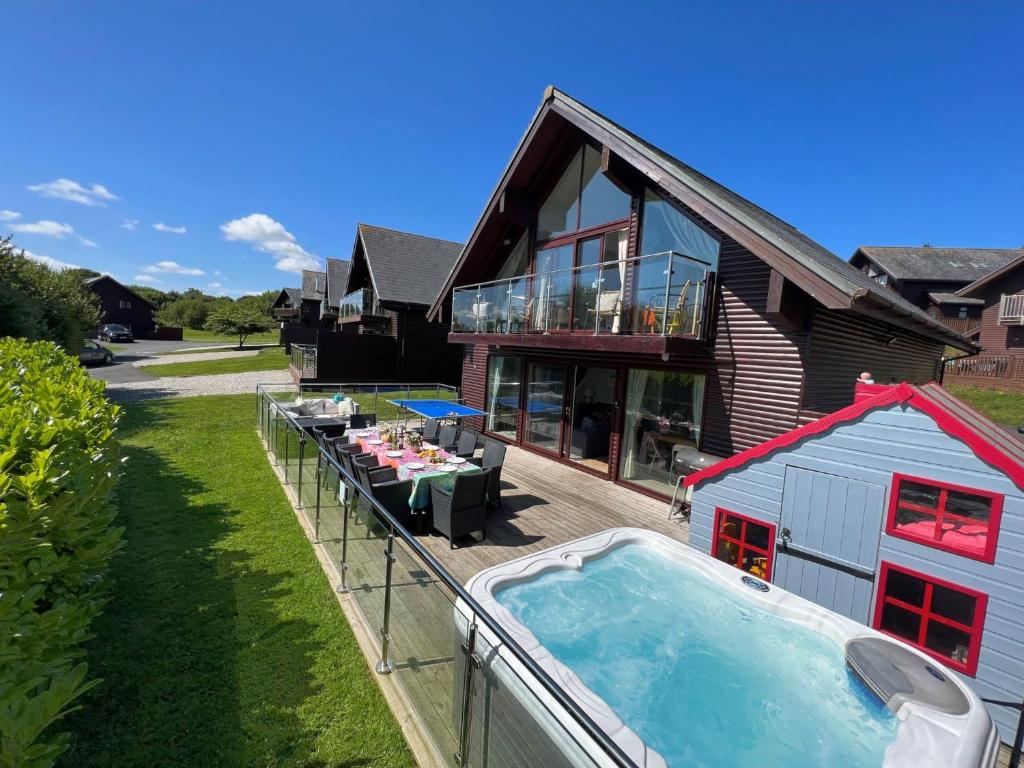 una casa con piscina al lado de una casa en Lodge 27, Retallack Resort & Spa, en Saint Columb Major