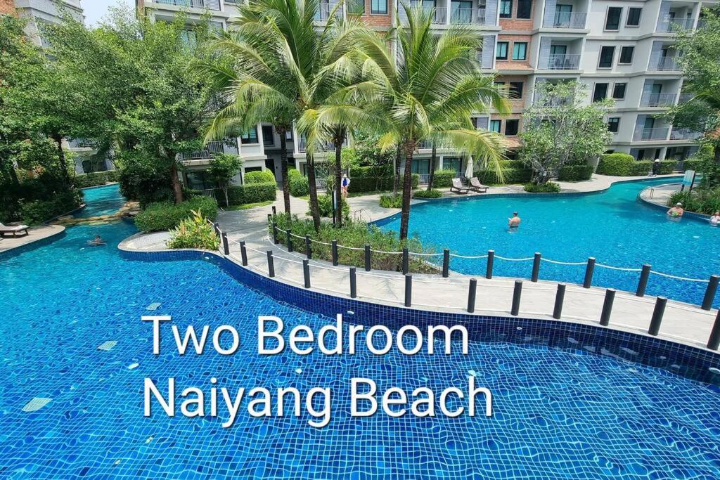 a swimming pool at a resort with text overlay two bedroom navarre beach at D4 The Title Residencies Naiyang Two Bedroom Phuket in Nai Yang Beach