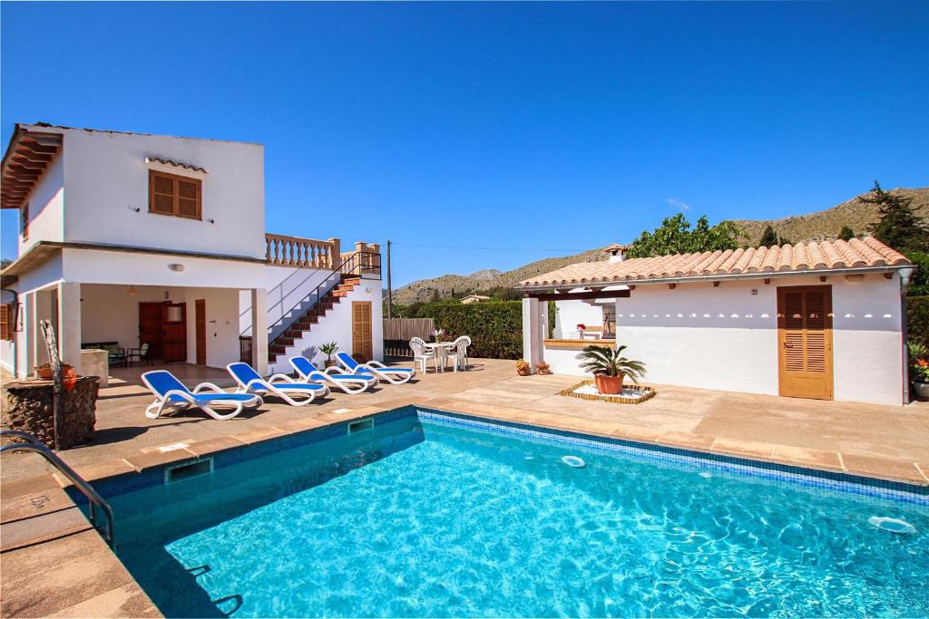 a villa with a swimming pool in front of a house at Villa La Vinya Can Oliver - Oliver in Pollença