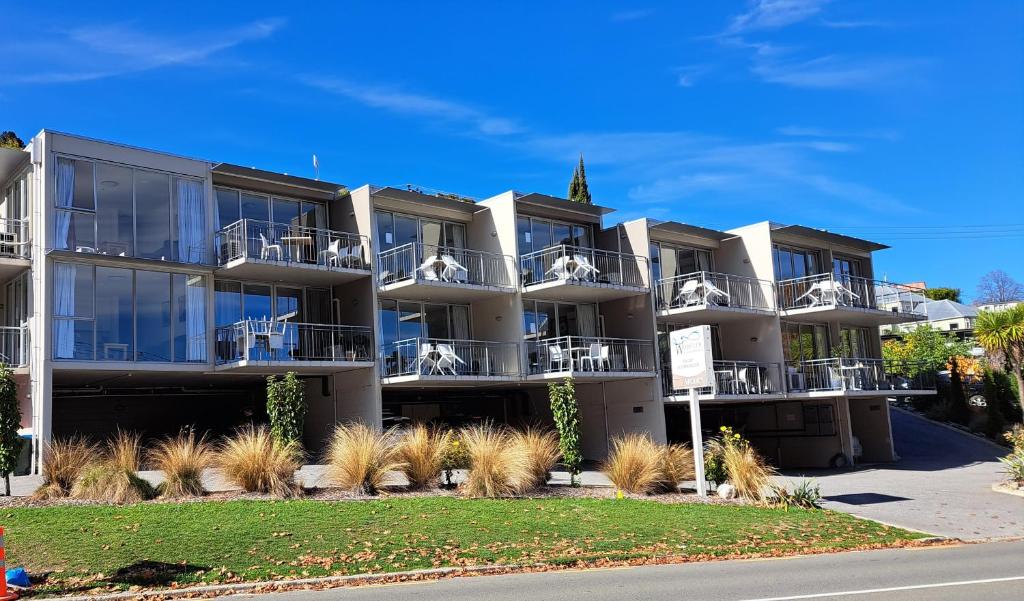 an apartment building with balconies on a street at Very Close to Town- Mountain Views in Queenstown