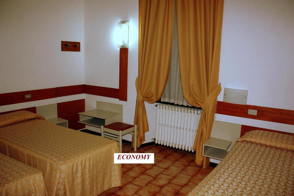 Postel nebo postele na pokoji v ubytování Piccolo Hotel