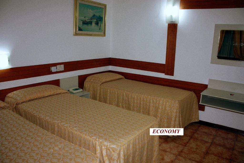 Postel nebo postele na pokoji v ubytování Piccolo Hotel