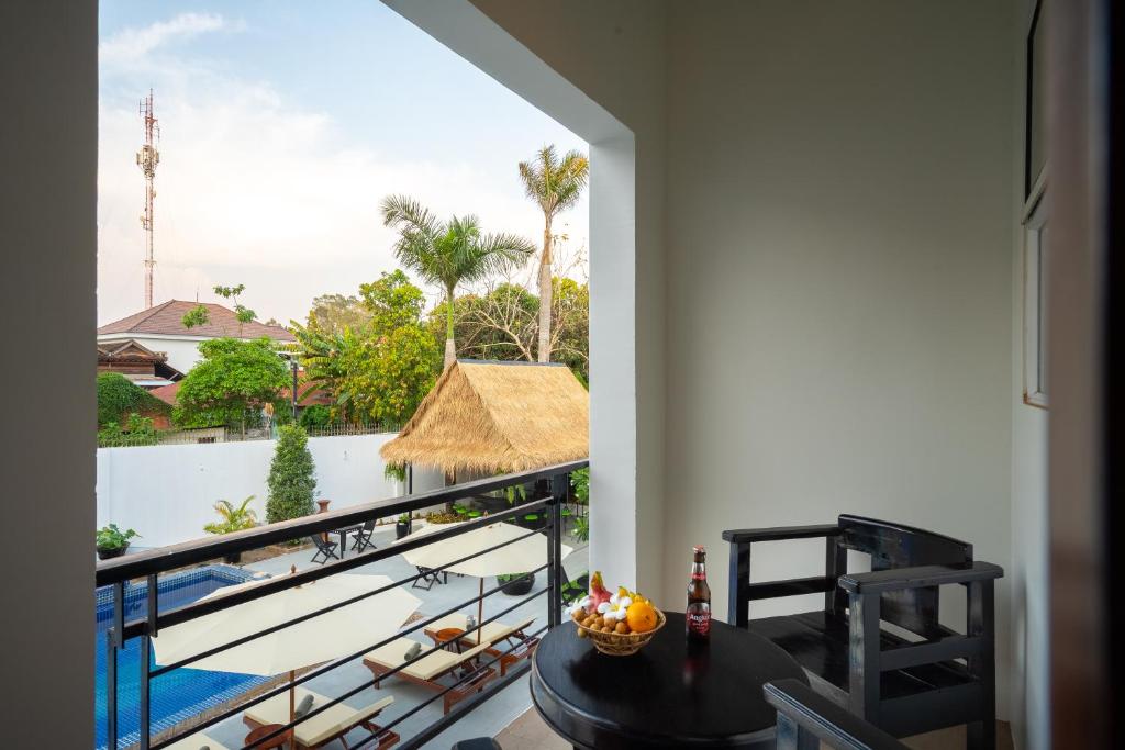 a balcony with a table and a view of the ocean at Sala Siem Reap Hotel in Siem Reap