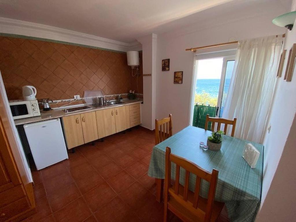 a kitchen with a table and a kitchen with a window at Cosy twin beds La Baja in Santa Cruz de Tenerife