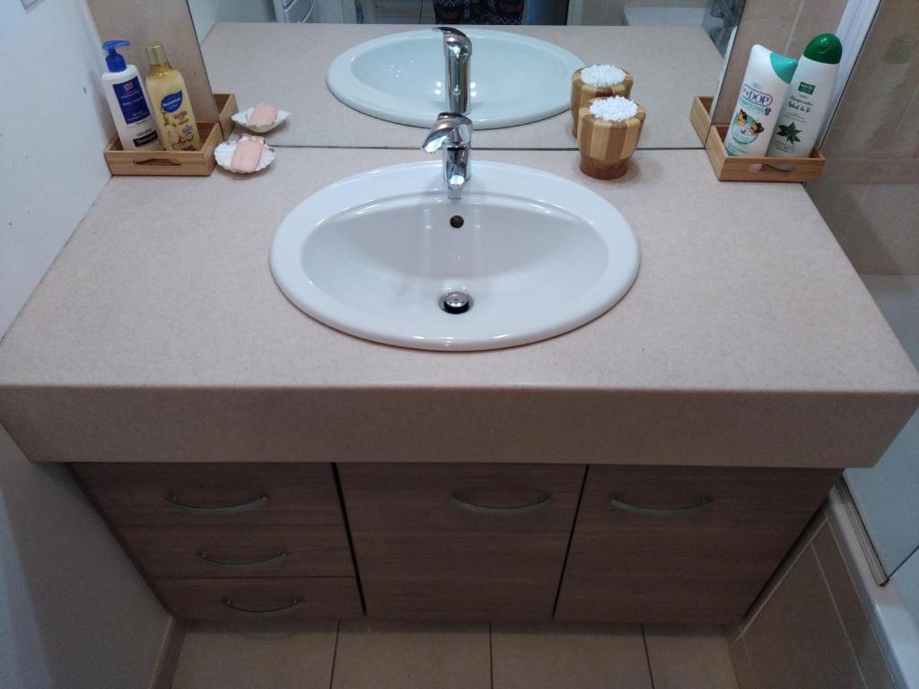 a bathroom sink with a white counter top with a sink at Rêve d une nuit d été in Aubagne