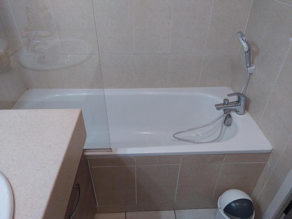 a bathroom with a bath tub with a faucet at Rêve d une nuit d été in Aubagne