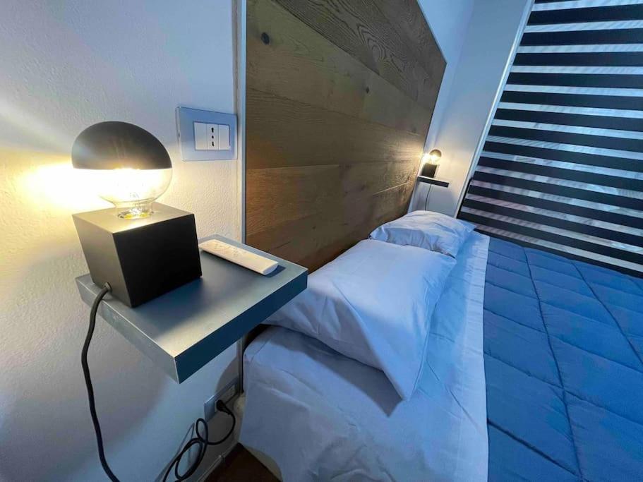 a bedroom with a bed and a desk with a lamp at Perugia Home Apartment La Finestra Di Fronte in Perugia