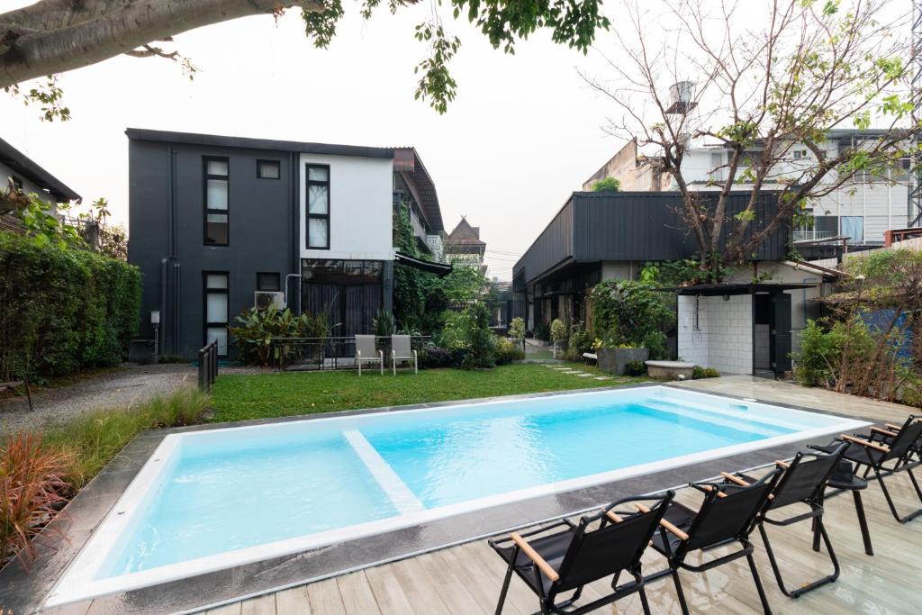 a swimming pool in the backyard of a house at Ombra House No. 21-24 in Chiang Mai