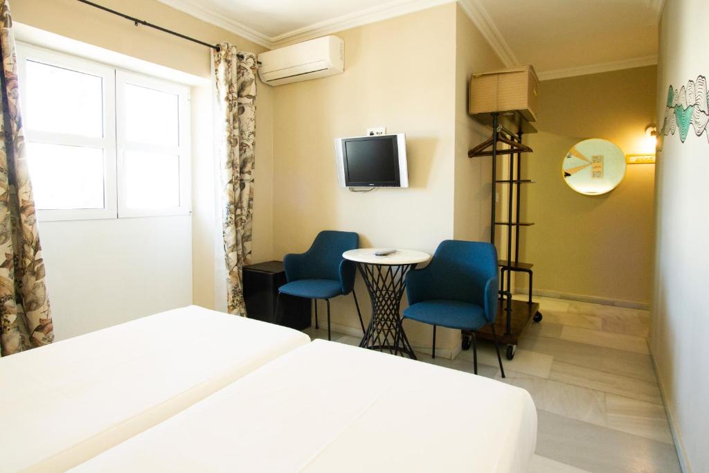 Televízia a/alebo spoločenská miestnosť v ubytovaní Alameda Hostal Boutique
