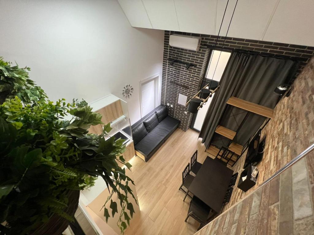 an overhead view of a living room with a brick wall at Grandera Apart`s - Melià i Fuster 23С in Valencia