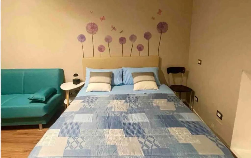 um quarto com uma cama e um sofá verde em Perugia Home Apartment Pinturicchio em Perugia