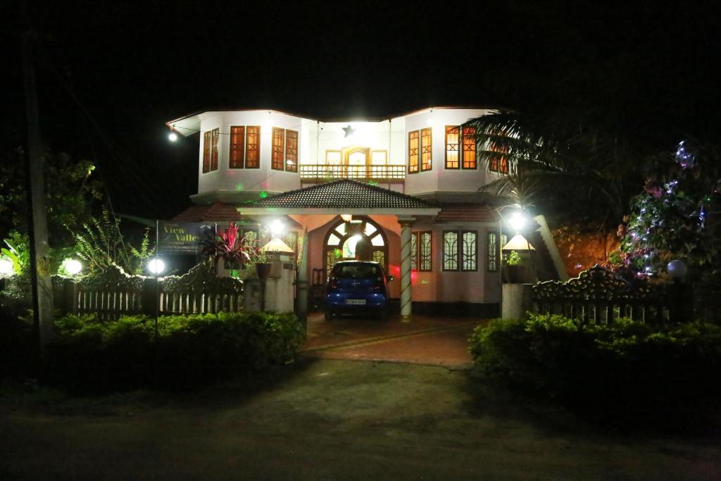 a house with a car parked in front of it at night at View Valley Homestay in Munnar