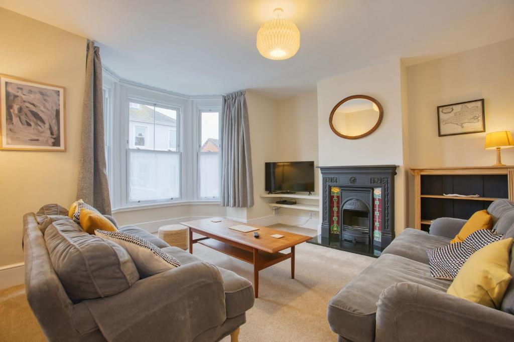 a living room with two couches and a fireplace at 5 Bedroom Family Retreat Exmouth, Devon in Exmouth