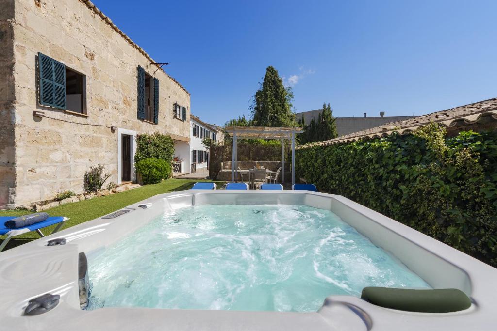 a hot tub in the yard of a house at Es Garroverar in Pollença