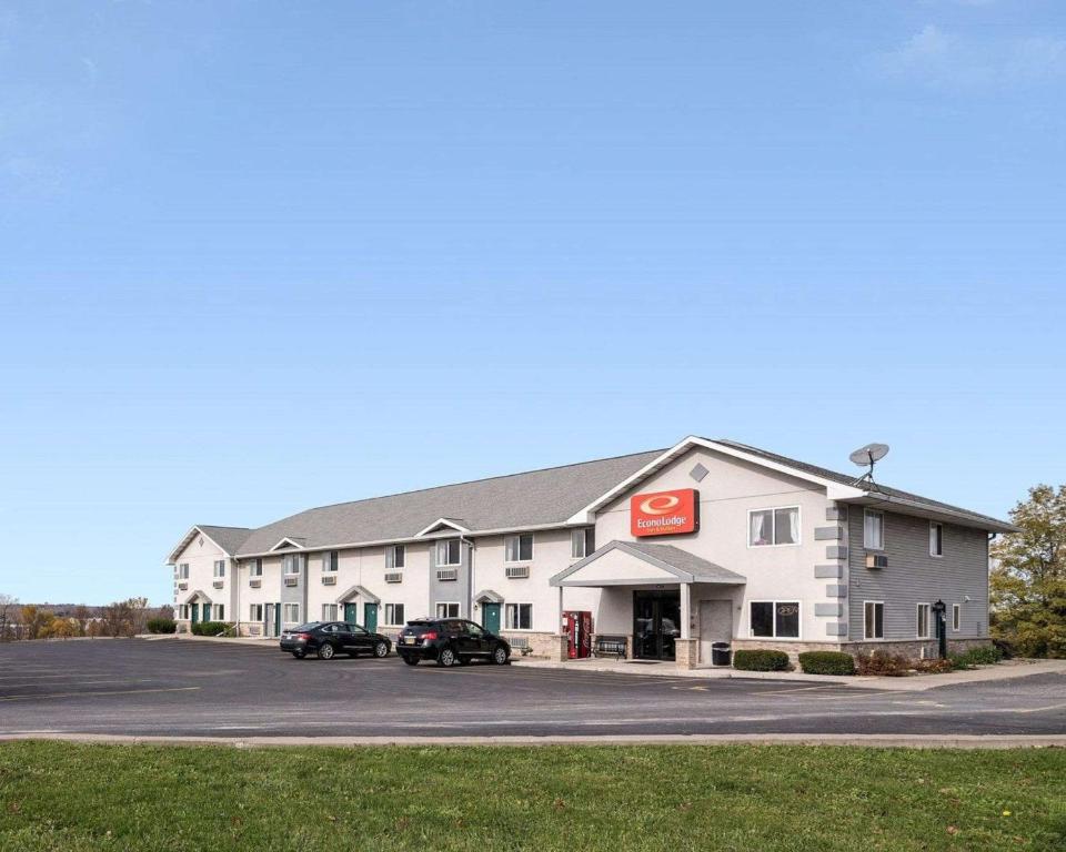 ein Hotel mit Autos auf einem Parkplatz in der Unterkunft Econo Lodge Inn & Suites in Canandaigua
