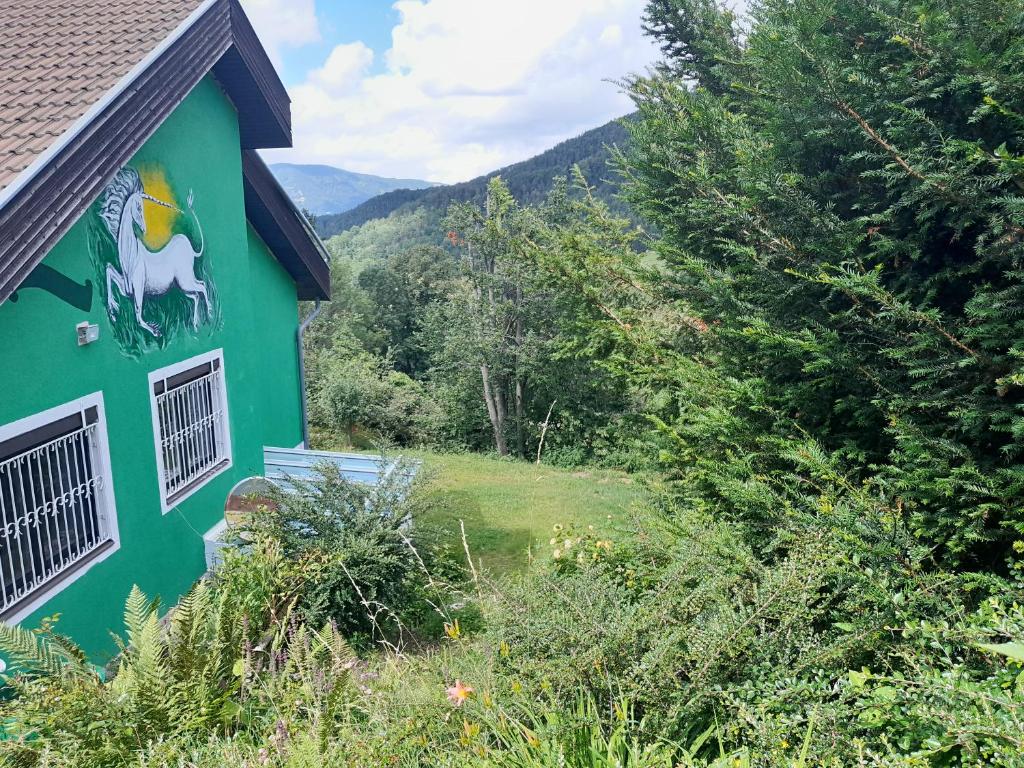 a green building with a painting of a horse on it at Einhornhaus in Schottwien