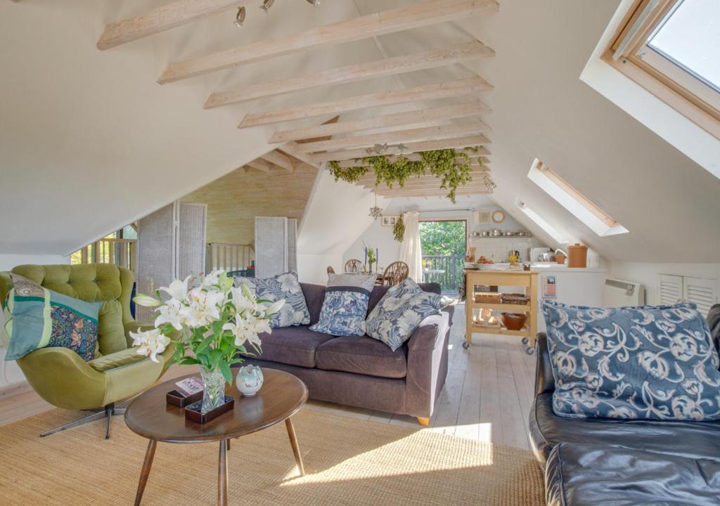 a living room with a couch and a table at Blackthorn Barn in Goudhurst