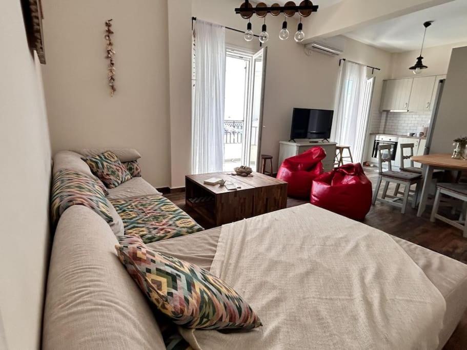 a living room with a couch and a table at Santa's Luxury Apartment in Tinos