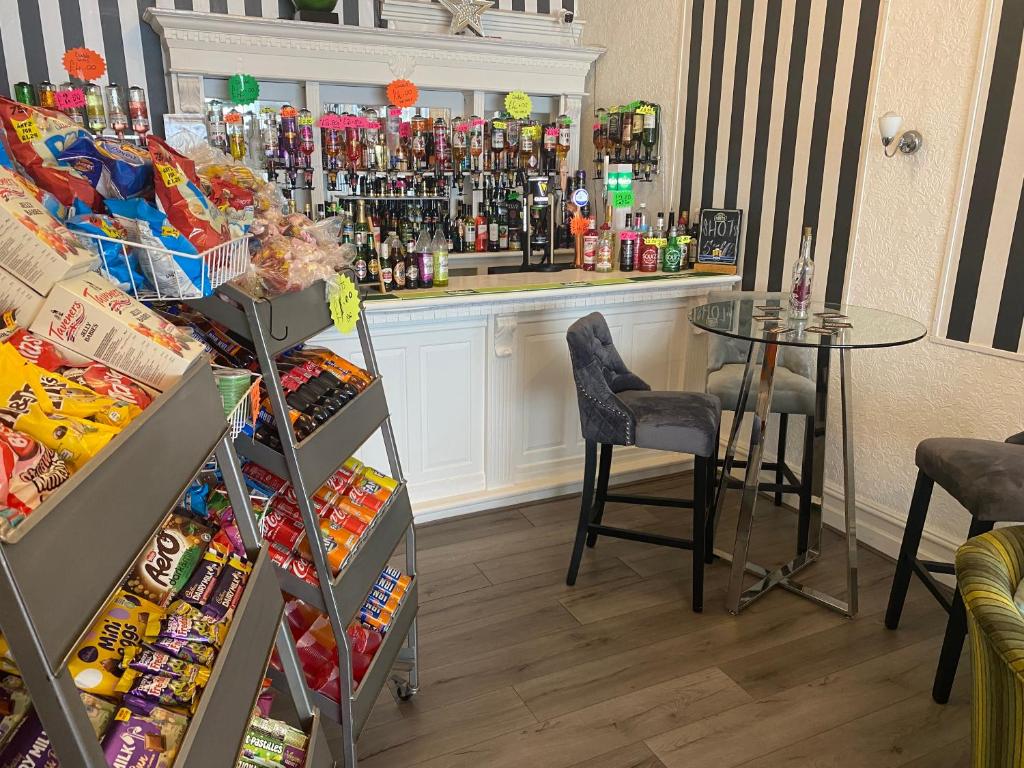 a bar with a table and a counter with drinks at The Cosy Nook in Blackpool