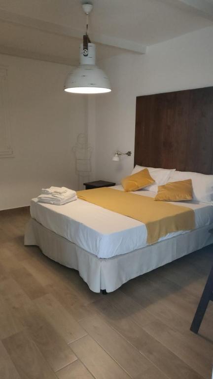 a bedroom with a large bed with yellow pillows at Lovin Puglia Vacation in Bari