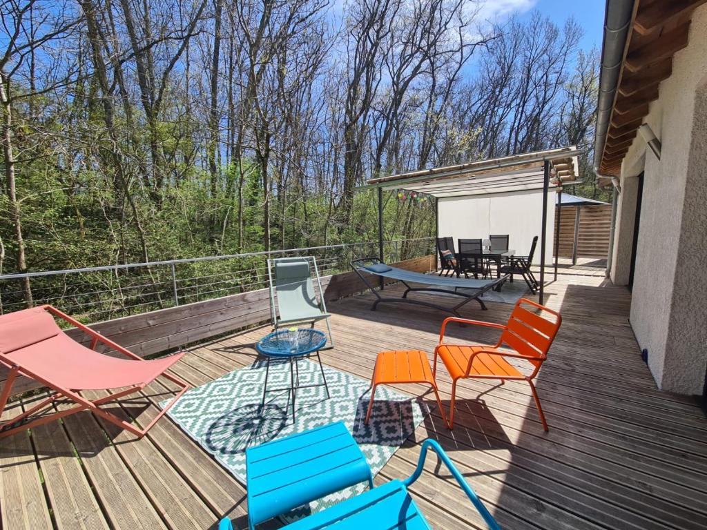 una terraza con sillas, una mesa y un banco en PAUSE NATURE Maison Cosmos avec parking gratuit en Lapeyrouse-Fossat