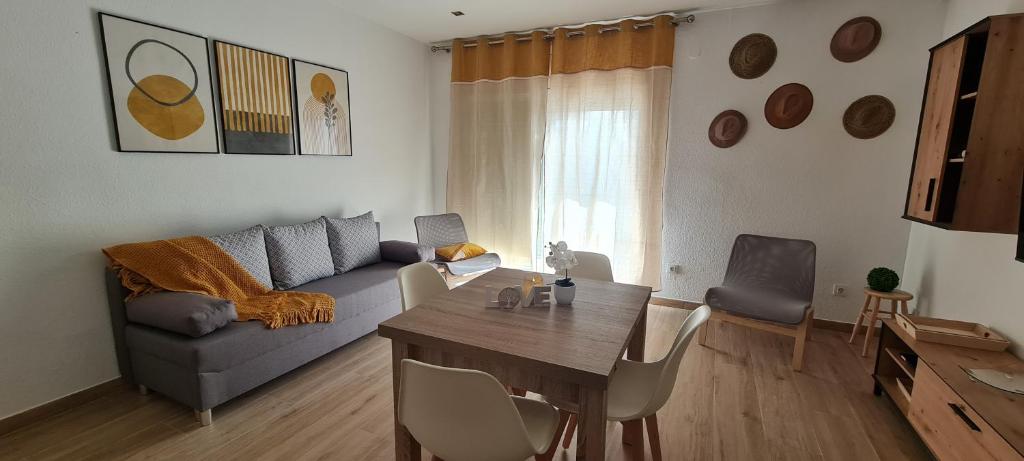 a living room with a couch and a table at LuengiHouse - Espectacular apartamento con piscina in Lloret de Mar